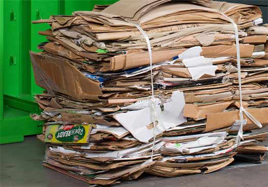 large pile of compacted cardboard recyclable waste