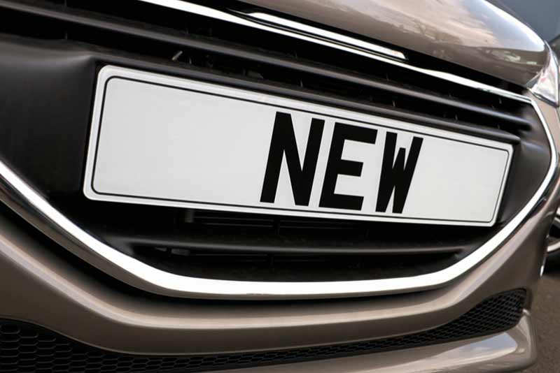 close up of a car's licence plate that reads NEW