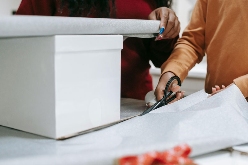 Christmas wrapping paper being cut